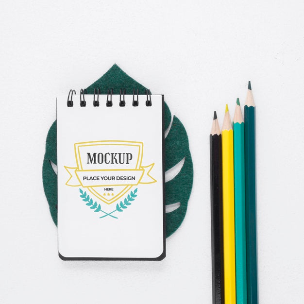 Top View Notepad Mock-Up Next To Stationery Elements Psd