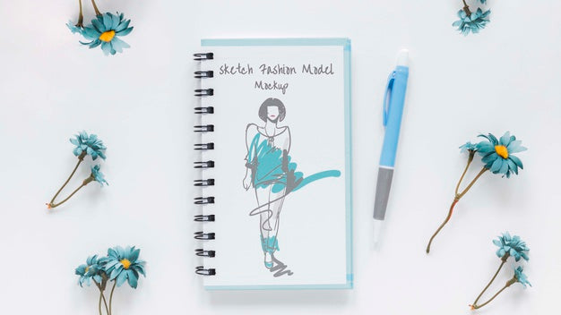 Top View Notepad With Drawing On The Desk Psd