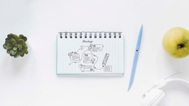 Top View Notepad With Drawing On The Desk Psd