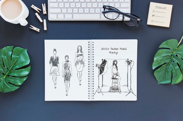 Top View Notepad With Drawing On The Desk Psd