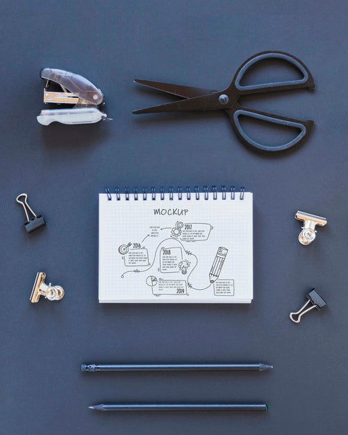 Top View Notepad With Drawing On The Desk Psd