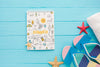 Top View Notepad With Flip Flops And Starfishes Psd