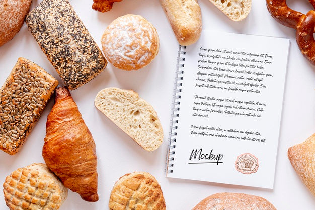 Top View Of Assortment Of Bread With Notebook Psd