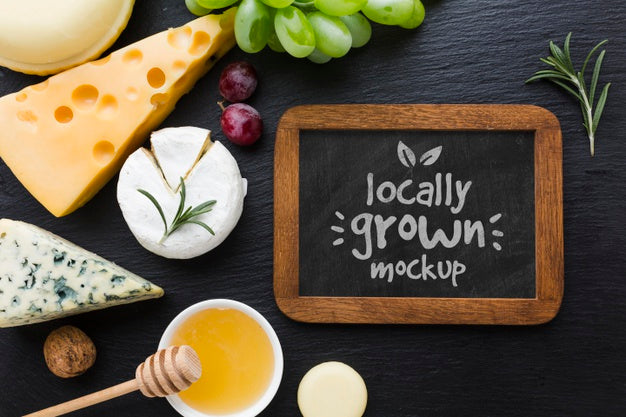 Top View Of Assortment Of Locally Grown Cheese With Blackboard Mock-Up Psd
