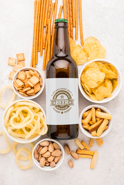 Top View Of Beer Bottle With Assortment Of Snacks Psd