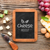 Top View Of Blackboard With Assortment Of Locally Grown Cheese And Grapes Psd