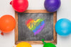 Top View Of Blackboard With Rainbow Colored Balloons Psd