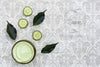 Top View Of Body Butter And Cucumber On Plain Background Mock-Up Psd