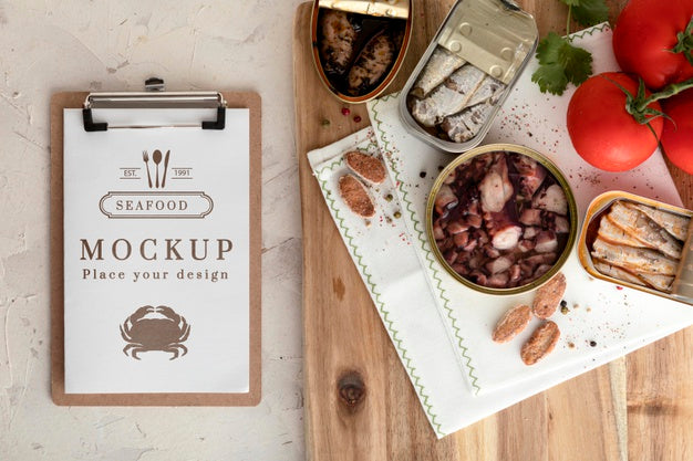 Top View Of Canned Fish With Notepad Psd