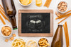 Top View Of Chalkboard With Beer Bottles And Assortment Of Snacks Psd