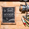 Top View Of Chalkboard With Fishing Rod And Bait Psd