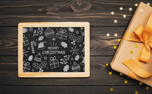 Top View Of Christmas Concept Chalkboard On Wooden Table Psd