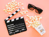 Top View Of Clapperboard With Popcorn Psd