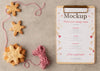 Top View Of Clipboard With Snowflake Cookies And String Psd