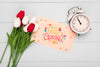 Top View Of Clock With Card And Spring Tulips Psd