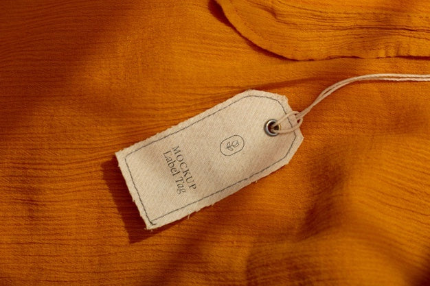 Top View Of Clothing Label On Orange Textile Psd