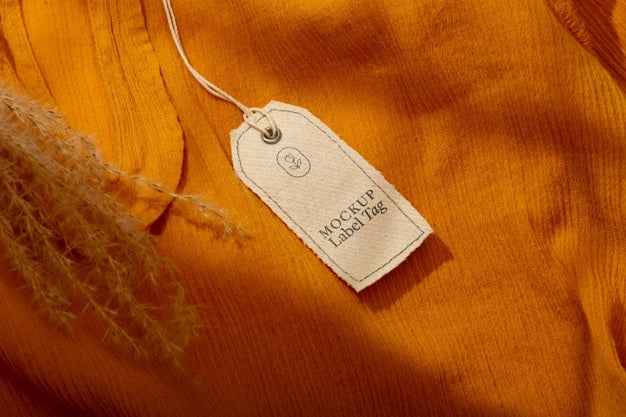 Top View Of Clothing Label On Orange Textile Psd
