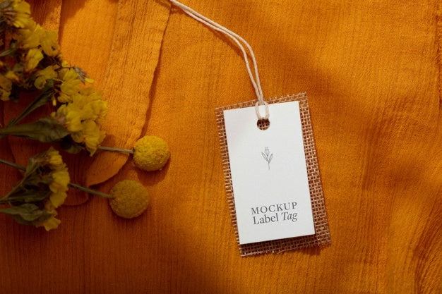 Top View Of Clothing Label On Orange Textile Psd
