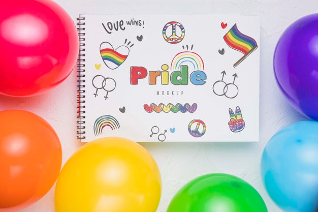 Top View Of Colorful Balloons With Notebook Psd