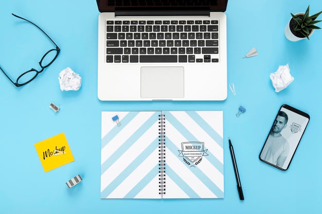 Top View Of Desk Surface With Laptop And Smartphone Psd