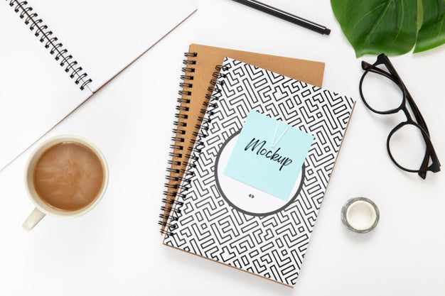 Top View Of Desk Surface With Noteboks Psd