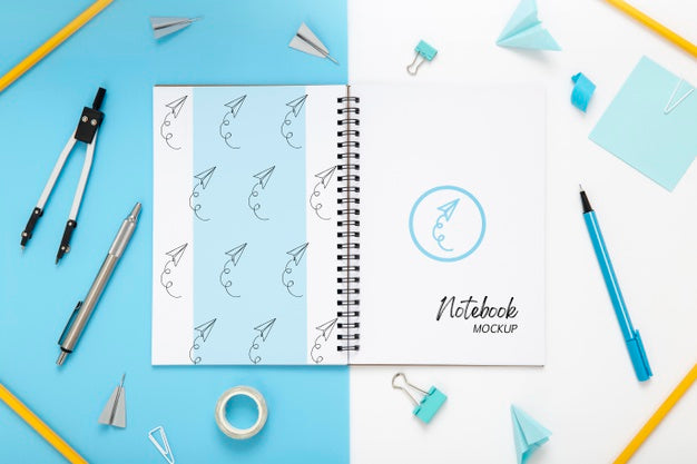 Top View Of Desk Surface With Notebook And Compass Psd