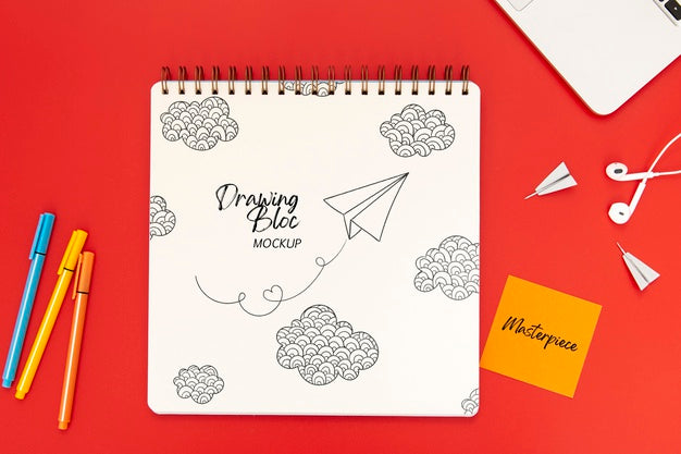 Top View Of Desk Surface With Notebook And Earphones Psd