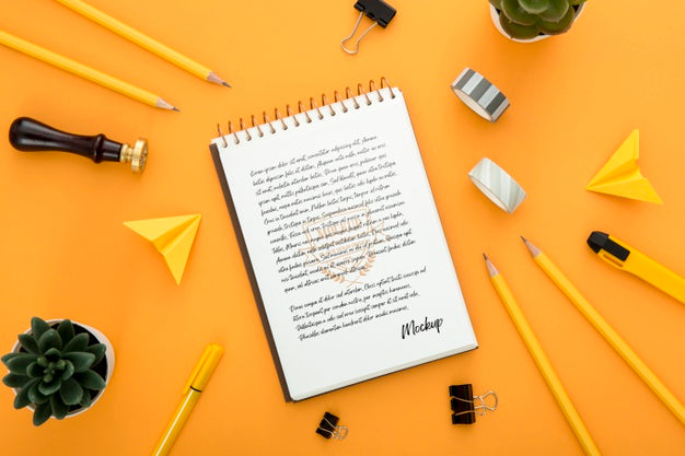 Top View Of Desk Surface With Notebook And Pencils Psd