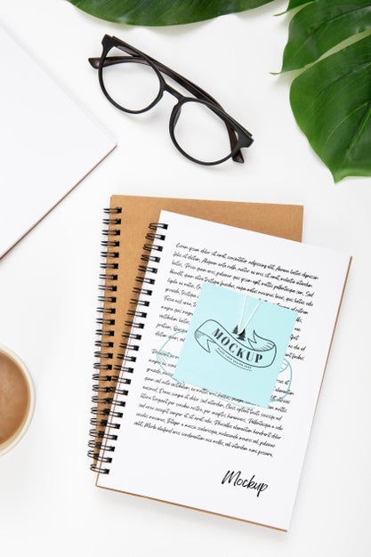 Top View Of Desk Surface With Notebooks And Leaves Psd