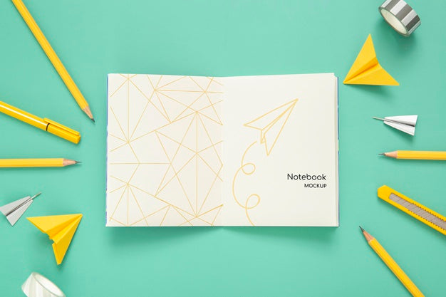 Top View Of Desk Surface With Pencils And Paper Airplanes Psd
