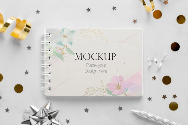 Top View Of Elegant Birthday Notebook With Ribbon And Confetti Psd
