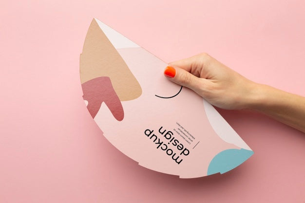 Top View Of Female Hands Holding Mock-Up Paper Fan Psd