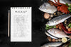 Top View Of Fish And Crustaceans With Notebook And Pen Psd