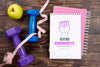 Top View Of Fitness Notebook With Apple And Weights Psd