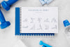 Top View Of Fitness Notebook With Weights And Water Bottle Psd