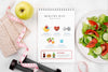 Top View Of Fitness Notebook With With Salad And Weights Psd