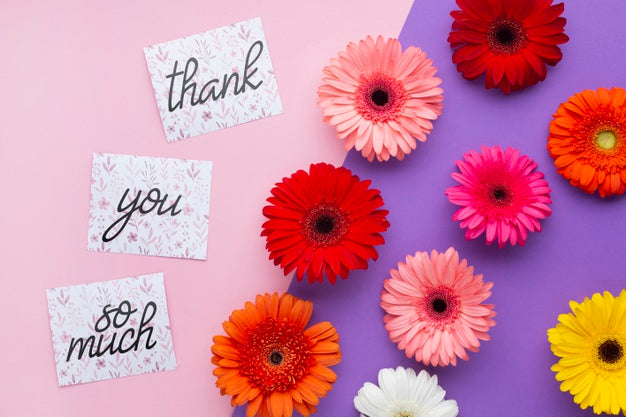 Top View Of Flowers And Letters On Pink And Purple Background Psd