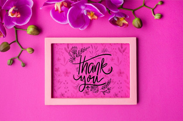 Top View Of Frame And Flowers On Pink Background Psd