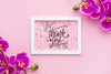Top View Of Frame Mock-Up And Flowers On Pink Background Psd