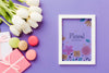 Top View Of Frame With Tulips And Macarons Psd