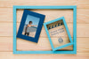 Top View Of Frames In Frame On Wooden Background Psd