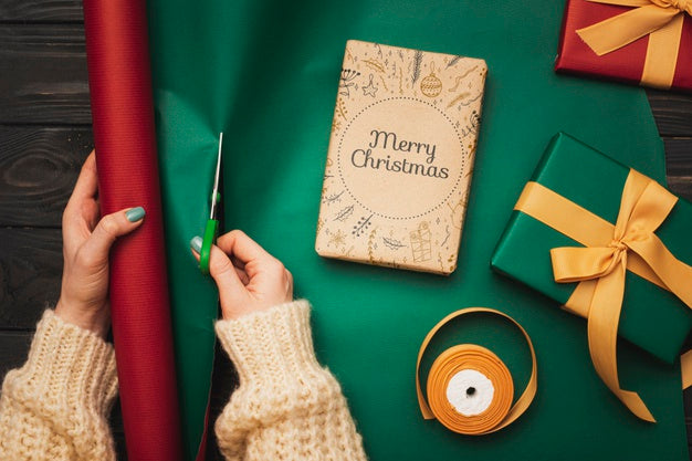 Top View Of Hands Wrapping Christmas Gifts Psd