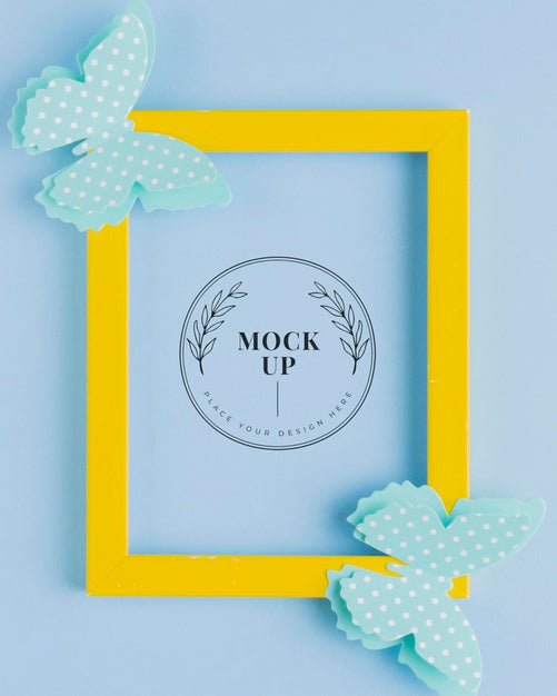 Top View Of Mock-Up Frame With Paper Butterflies Psd