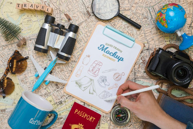 Top View Of Mock-Up Notepad With Traveling Essentials And Camera Psd