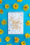Top View Of Notebook And Flowers On Blue Background Psd