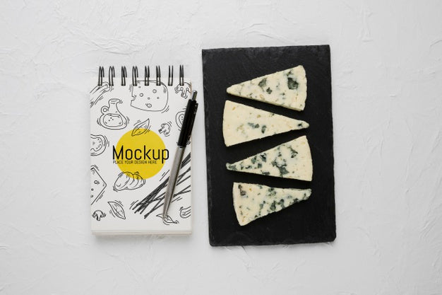 Top View Of Notebook And Pen With Moldy Cheese Psd