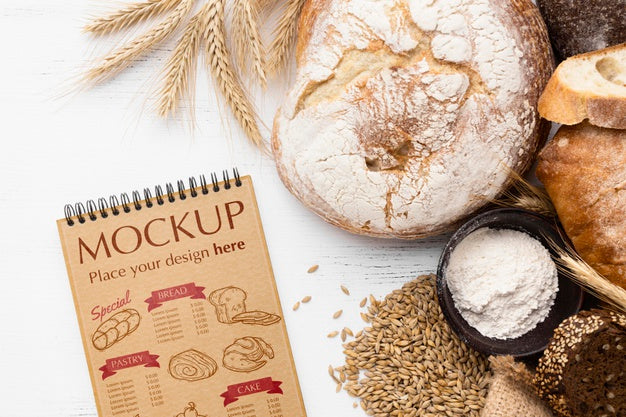 Top View Of Notebook With Bread And Wheat Psd