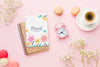Top View Of Notebook With Clock And Macarons Psd