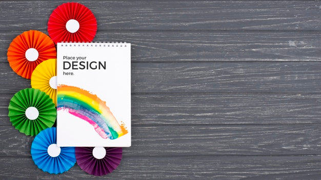 Top View Of Notebook With Colorful Rosettes Psd