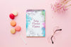 Top View Of Notebook With Flowers And Macarons Psd